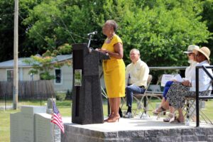 Jean Green, president of the Lincoln Cemetery Project Association, delivers remarks at the Gettysburg Black History Trail unveiling Wednesday at Lincoln Cemetery. Behind her, from left to right, are Wayne Motts, president emeritus and historian of the Gettysburg Foundation; Destination Gettysburg Director of Partnership Amy Welsh and Gettysburg Mayor Rita C. Frealing.